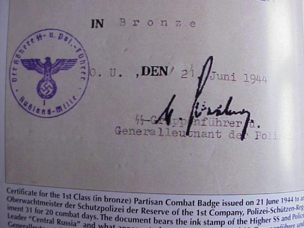 Partisan badge doc book sig.JPG